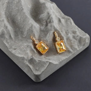 Detailed macro view of gold plated rectangular zircon earring with micro diamond accents