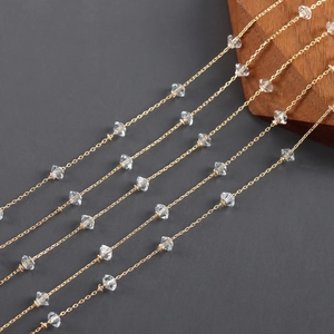 Close-up of 18k gold plated chain with faceted clear crystals for DIY jewelry making