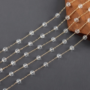 Detailed macro view of 18k gold-plated O-chain featuring faceted clear crystal beads