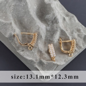 Macro view of 18k gold plated flower petal earring clasps with size markings
