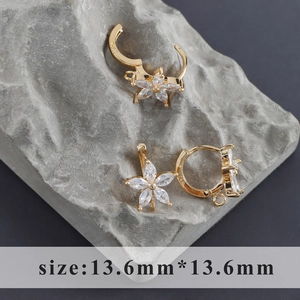 Macro detail of 18k gold plated S925 silver flower earring with marquise cubic zirconia