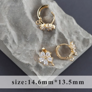 Macro shot of 18k gold plated flower earring hooks with cubic zirconia and DIY rings