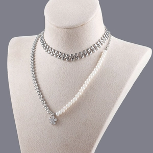 18k gold plated hollow leaf and heart link chain jewelry on a beige model stand
