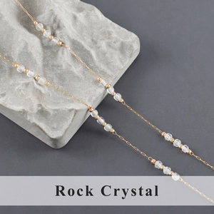 Detail of 1m handmade rock crystal bead chain with polished gold stainless steel links