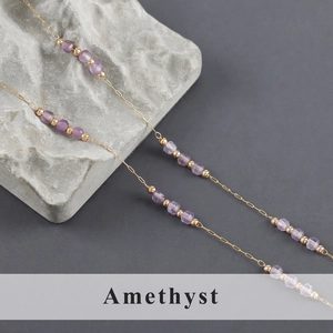 Detail showing gold stainless steel chain with natural amethyst purple gemstone beads