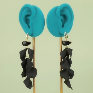 Long tassel earrings with black faceted stones and gold plated petal accents on stand