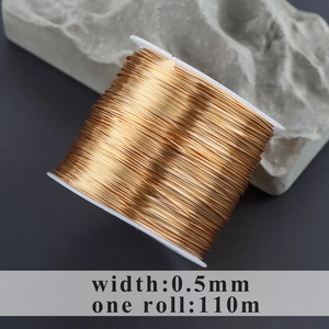 Close-up of 18k gold plated 0.5mm jewelry craft wire on spool with 110m length