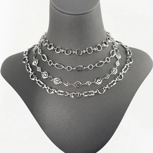 Silver oversized hollow chain necklaces set on grey mannequin with mixed link patterns