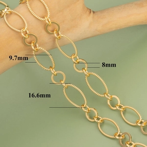 18k gold plated chunky link chain with spiral textured oval rings on a wooden branch