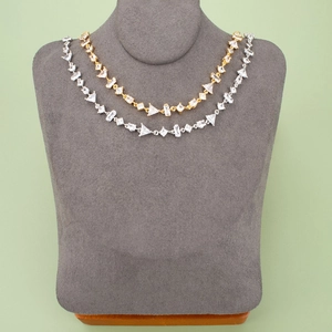 Elegant gold and silver geometric zircon necklaces displayed on velvet jewelry stands