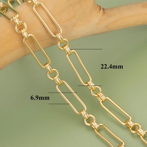 18k gold plated paperclip chain bracelet with 22.4mm by 6.9mm links on wooden stand