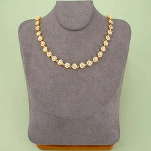 Gold plated copper sunburst necklace with zircon pendants on a grey velvet display