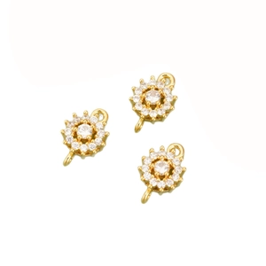 Three gold-plated sunflower charms with white cubic zirconia on white background