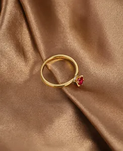 Detailed macro of gold-plated ring featuring heart red zircon and micro-set diamonds