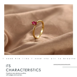 Detail of gold brass ring with red oval zirconia and micro-pave crystals on silk