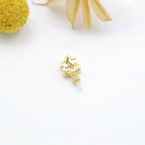 Macro shot of gold star pendant setting with sparkling pavé cubic zirconia inlay