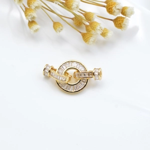 Macro detail of gold plated necklace clasp connector with micro-paved white zircons