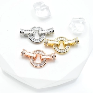 Micro-paved zircon necklace clasps in silver, gold, and rose gold on a clean display
