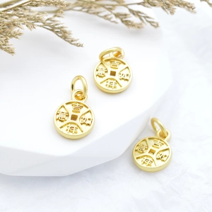Three gold coin charms with Auspicious Ru Yi characters on a white display stand