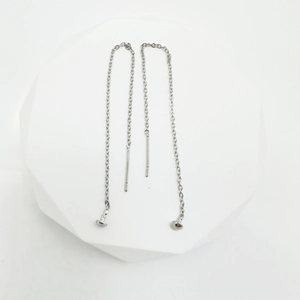Minimalist silver chain threader earrings with round bead ends on white platform