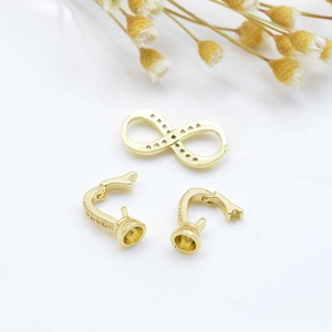 Gold plated DIY jewelry set with infinity connector and zircon lobster clasps on white background