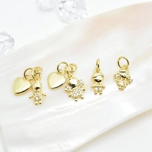 Golden heart and micro-pave zircon figure pendants displayed on elegant pearl texture