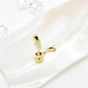 Golden bunny ear pendant base with zircon pavé on iridescent pearl shell backdrop