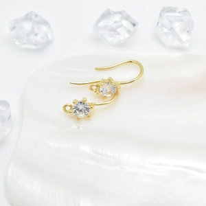 Gold plated six-claw cubic zirconia ear hooks for DIY jewelry making on white shell tray