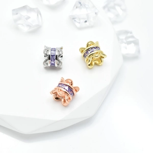 Macro view of micro-pave purple zircon beads in silver, gold, and rose gold plating