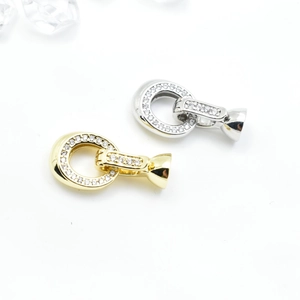 Gold and silver jewelry connectors with cubic zirconia on a bright white background