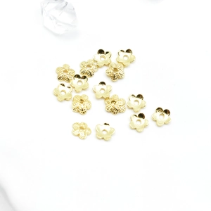 Gold hollow five-petal flower bead caps for DIY jewelry making displayed on a white background
