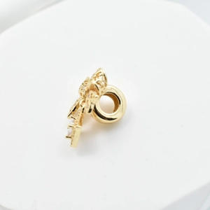 Golden bow charm with white zircons and large hole for DIY jewelry making
