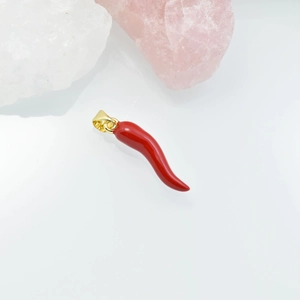 Red enamel chili pepper pendant with gold metal clasp on decorative white stones