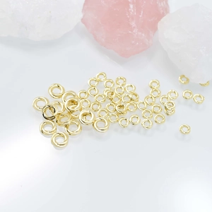 Polished gold twist spacer beads for DIY jewelry making displayed with crystals