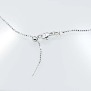 Detail view of adjustable 18k gold plated copper ball chain with lobster clasp and slider