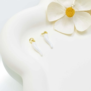 Minimalist white cornicello chili pendants with gold rings on a clean white background