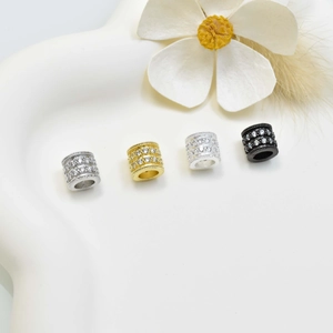 Set of four crystal inlaid cylinder spacer beads in silver gold and black finishes