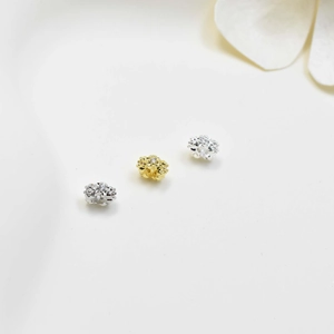 Macro view of zircon-studded flower bead charms for DIY jewelry and pearl necklace
