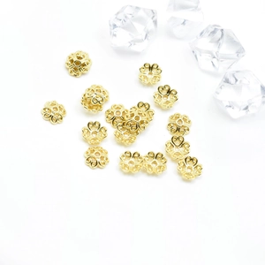 Hollow flower gold bead caps for jewelry making with elegant metallic finish and floral shape