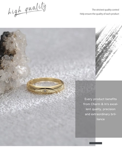 Macro detail of a minimalist gold ring featuring a micro-set star and zircon stone