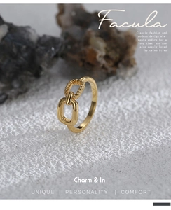 Detail of gold-plated brass ring with interlocking smooth and twisted rope texture design