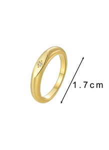 Detail view of gold minimalist ring with star engraving and 1.7cm diameter spec