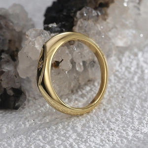 Minimalist gold plated ring with engraved star detail on crystal stone display