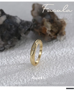 Detailed view of golden ring with star engraving and micro zircon on stone background