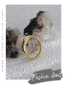 Close-up of gold-plated signet ring with star engraving on polished mirror finish surface