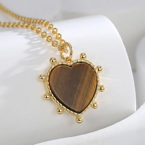 Vintage heart-shaped tiger eye stone pendant necklace with gold beaded frame detail