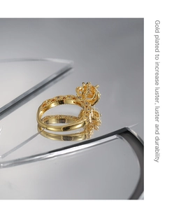 Detailed macro shot of the hollow-out floral gold ring with sparkling cubic zirconia
