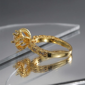 Macro side view of golden crown ring with cubic zirconia inlay and polished finish