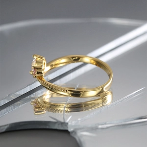 Golden ring featuring beaded texture and dual-tone pink and clear cubic zirconia stones