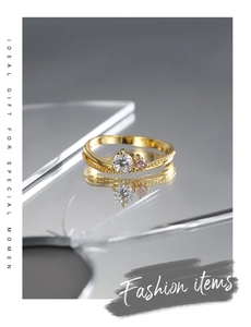 Macro shot of two-tone zircon ring with gold band on a reflective mirror surface